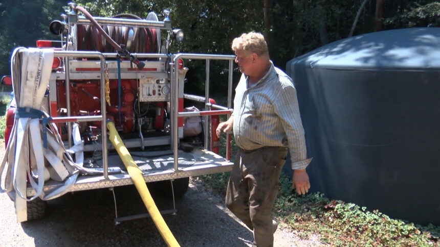 Mark Kuchler loads up water into his fire truck