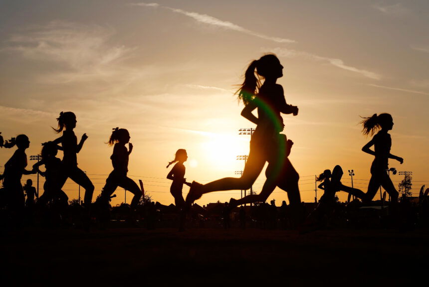 Runners compete in a 5k at sunset in Corona, California.