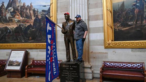 210106151337-protester-pose-with-capitol-statue-live-video-19