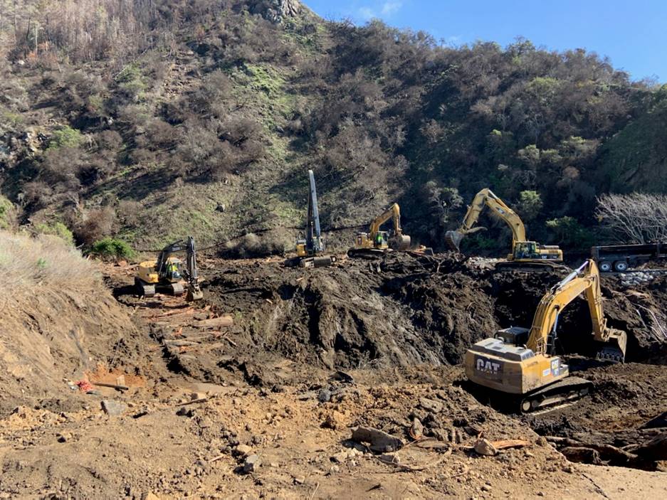 This photo taken on 2/11/2021 shows excavators clearing debris and mud near Rat Creek.