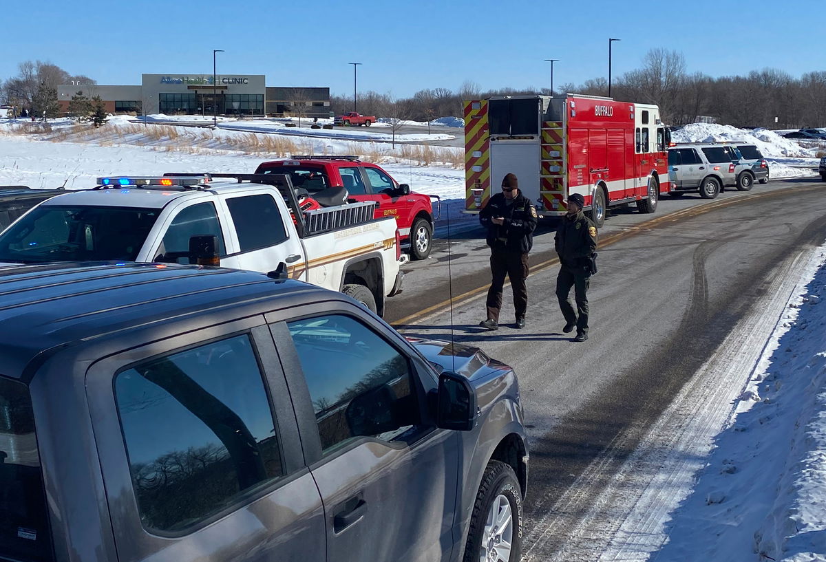 Law enforcement personnel and first responders gather outside of the Allina Health clinic on Tuesday, February 9, 2021, in Buffalo, Minnesota.