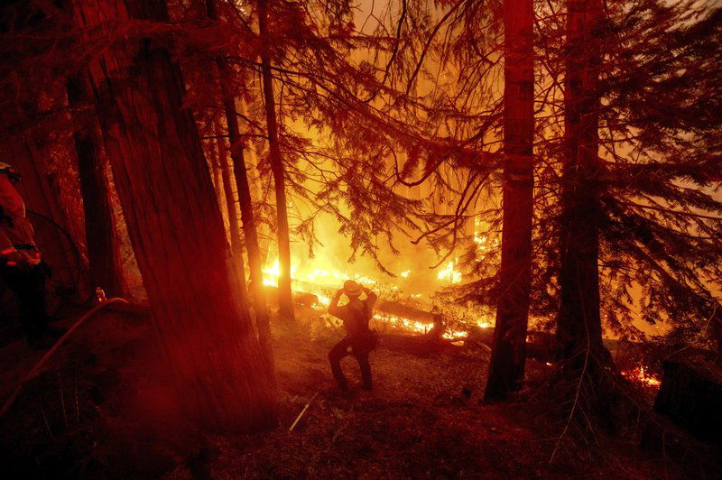  In this Sept. 7, 2020, file photo, a firefighter battles the Creek Fire in the Shaver Lake community of Fresno County, Calif. California will authorize $536 million for wildfire mitigation and forest management projects before the worst of the fire season strikes later this year, Gov. Gavin Newsom and legislative leaders said Thursday, April 8, 2021.