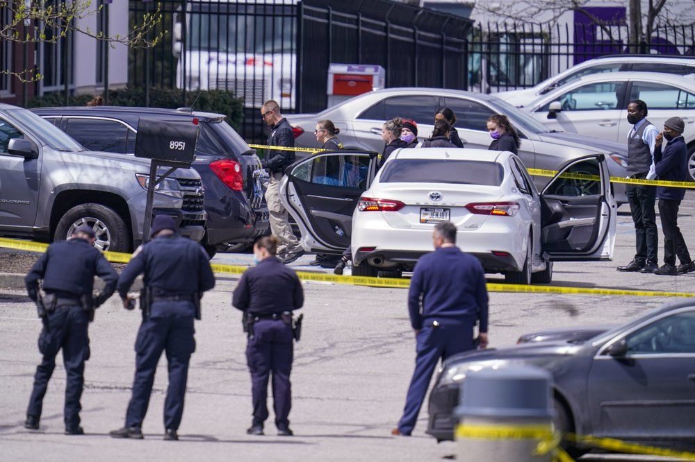 Law enforcement confer at the scene, Friday, April 16, 2021, in Indianapolis, where multiple people were shot at a FedEx Ground facility near the Indianapolis airport. 