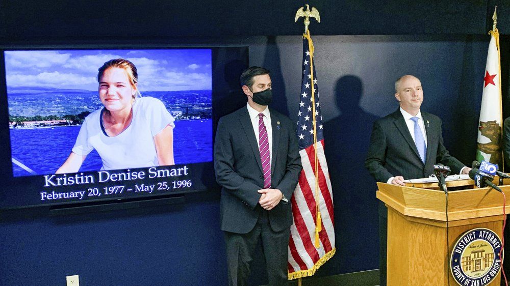 San Luis Obispo District Attorney Dan Dow announces a murder charge is filed against Paul Flores in the Kristin Smart case, as Deputy District Attorney Chris Peuvrelle listens at left, during a news conference, Wednesday, April 14, 2021, in Arroyo Grande, Calif. Smart, a missing California college who was killed in 1996 during an attempted rape by a fellow student, and the suspect’s father helped hide her body, the San Luis Obispo County district attorney said Wednesday. 