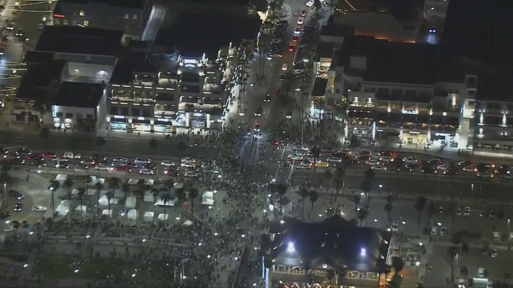 This Saturday, May 22, 2021 aerial screenshot provided by FOX 11 KTTV shows people gathered at the Huntington Beach pier in Huntington Beach, Calif. Police in Huntington Beach estimate that at least 1,000 people gathered by the fire pits on the sand Saturday night. A birthday party invitation that went viral on TikTok brought hundreds of people to a raucous celebration on a Southern California beach, prompting police to declare an unlawful assembly and arrest about 150 people after they refused orders to disperse. 