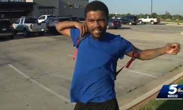 Donte Franklin puts on his backpack as he prepares to walk home after he's completed his shift. Franklin walks 17 miles round trip to get to and from work.