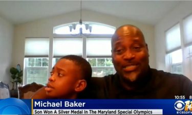 Michael Baker (right) holds his 10-year-old son