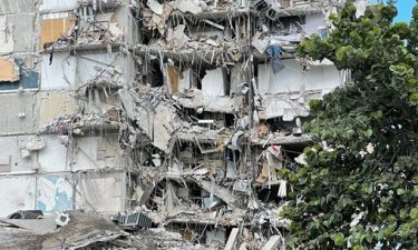 Maria Fernanda Martinez and Mariana Cordeiro look on as search and rescue operations continue at the site of the partially collapsed 12-story condo building on Friday in Surfsid