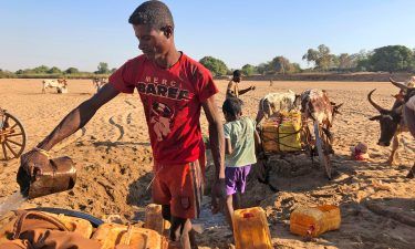 Men dig for water in the dry Mandrare river bed in Madagascar on November 9