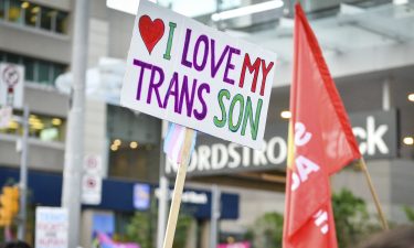 Protesters gather ahead of the Sydney Gay and Lesbian Mardi Gras parade next to a banner with the colors of the trans movement on March 6 in Australia.