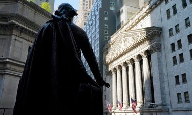 The Federal Hall statue of George Washington overlooks the New York Stock Exchange on June 7. The Dow fell 400 points shortly after the opening bell Friday.