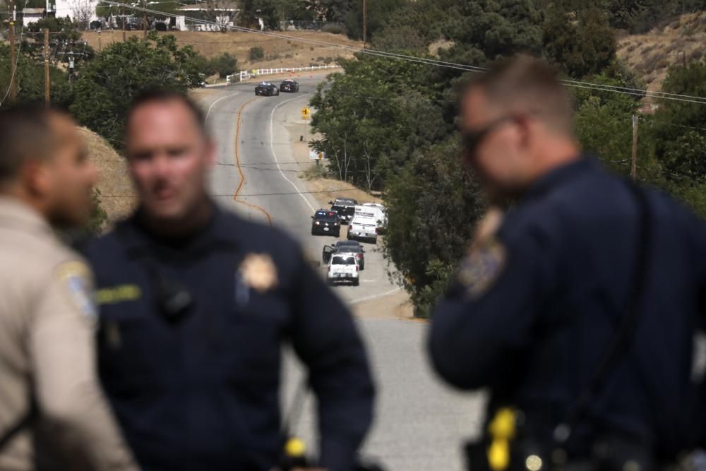 Law enforcement authorities close off a road during an investigation for a shooting at fire station 81 in Santa Clarita, Calif. on Tuesday, June 1, 2021. An off-duty Los Angeles County firefighter fatally shot a fellow firefighter and wounded another at their fire station Tuesday before barricading himself at his home nearby, where a fire erupted and he was later found dead, authorities said.