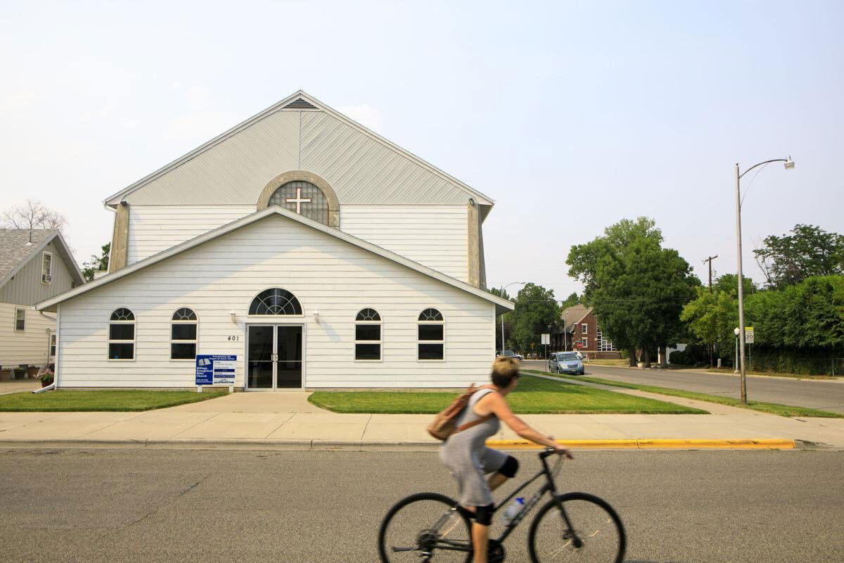<i>Billings Gazette</i><br/>A woman rides her bicycle past the First Evangelical Free Church Friday July 16