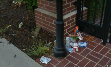 Trash sits outside the gate of Los Angeles Mayor Eric Garcetti's home. Protestors angered over an odinance restricting homeless encampments vandalized the property on July 29.