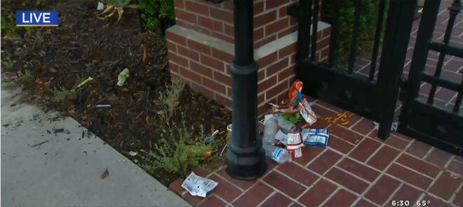<i>KCAL KCBS</i><br/>Trash sits outside the gate of Los Angeles Mayor Eric Garcetti's home. Protestors angered over an odinance restricting homeless encampments vandalized the property on July 29.