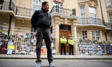 Former Myanmar Ambassador to the UK Kyaw Zwar Minn listens to a statement being read on his behalf as he stands outside the Myanmar Embassy on April 8 in London