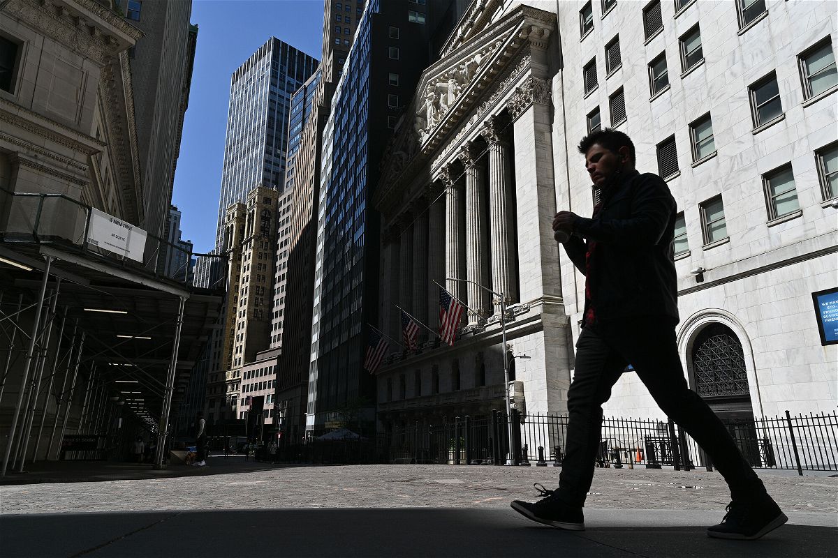 <i>Erik Pendzich/Shutterstock</i><br/>People walk past the New York Stock Exchange on Wall Street in New York.