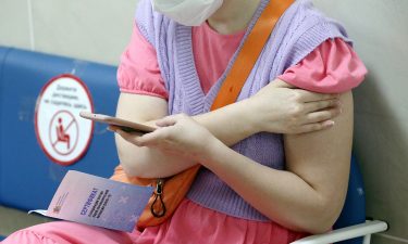 A woman is pictured with a vaccination certificate after receiving a shot in the city of Ivanovo on June 18.