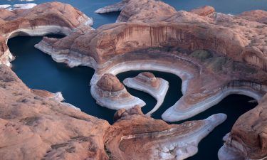 The tall bleached "bathtub ring" is visible on the rocky banks of Lake Powell at Reflection Canyon on June 24