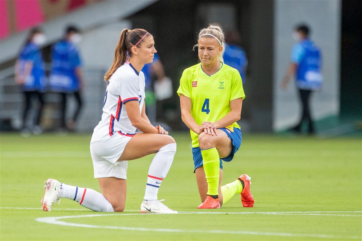 <i>Tim Clayton/Corbis Sport/Getty Images</i><br/>Alex Morgan of the US and Hanna Glas of Sweden take a knee before the start of their match.