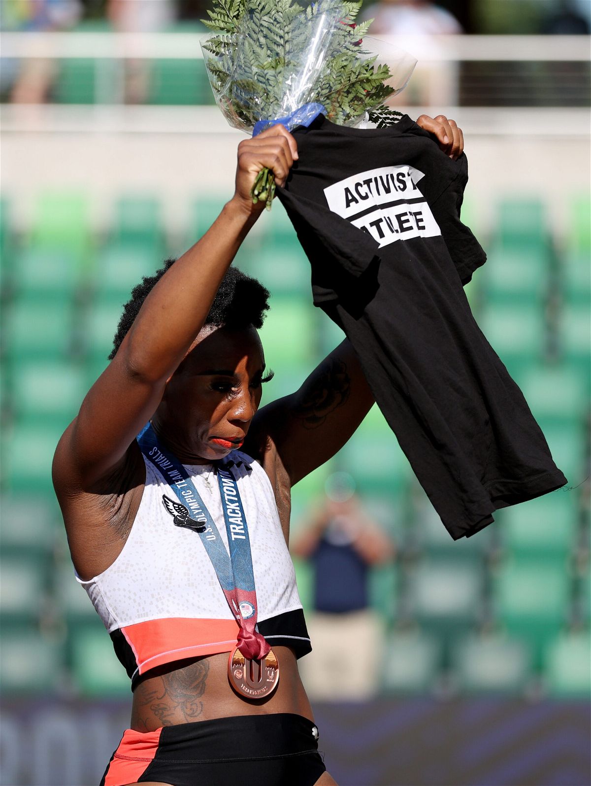<i>Patrick Smith/Getty Images North America/Getty Images</i><br/>Gwen Berry holds up a shirt reading 