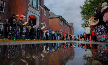 Drummers line the front of the former Kamloops Indian Residential School to welcome a group of runners from the Syilx Okanagan Nation on June 5.