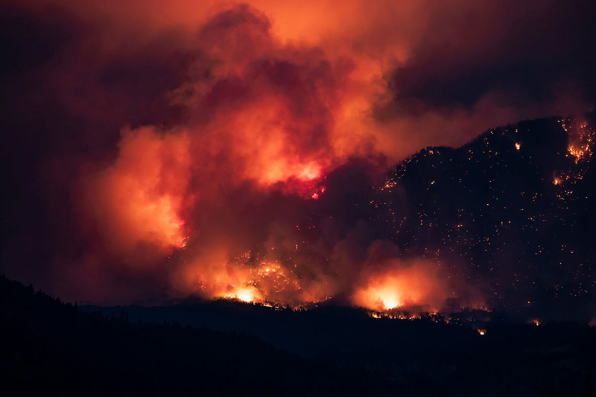 <i>Darryl Dyck/The Canadian Press/AP</i><br/>A wildfire burns on the side of a mountain in Lytton