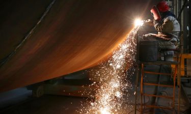 A welder works at a factory of wind farm facilities in Rudong county in east China's Jiangsu province on June 7. China is releasing its latest quarterly economic growth figures on July 15