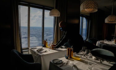 An employee sets a table at Cyprus Restaurant on the Celebrity Edge cruise ship on June 27.