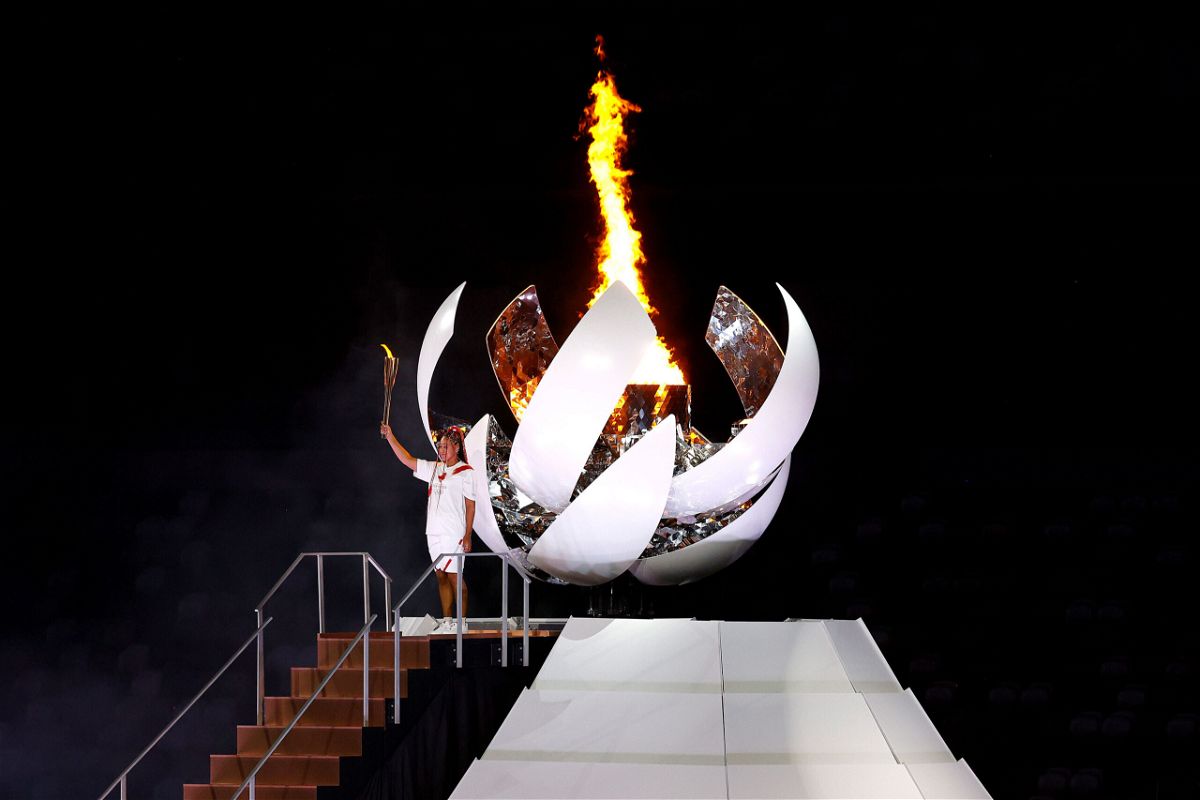 <i>Maddie Meyer/Getty Images</i><br/>Naomi Osaka gestures after lighting the Olympic cauldron during the opening ceremony at the Olympic Stadium.