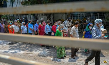 People line up to receive coronavirus vaccine shots in Mumbai