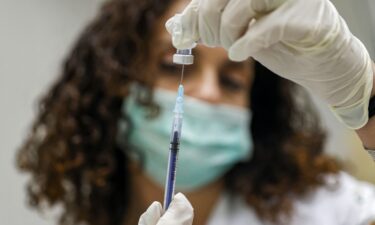 A medic prepares a dose of the Pfizer-BioNTech Covid-19 vaccine at the Clalit Healthcare Services in Holon