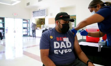 Leslie Garcia administers a Covid-19 vaccination dose to Raul Zarate at a clinic in South Los Angeles on June 25 in Los Angeles