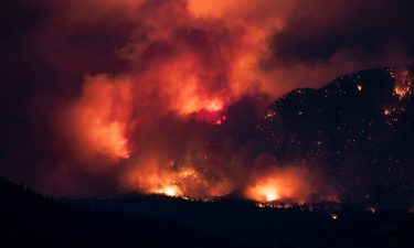 A wildfire burns on the side of a mountain in Lytton on July 1.