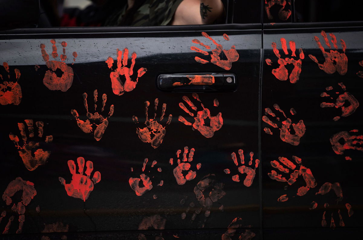 <i>Darryl Dyck/AP</i><br/>Handprints on the side of a truck riding in a convoy of vehicles in support of the Tk'emlups te Secwepemc people