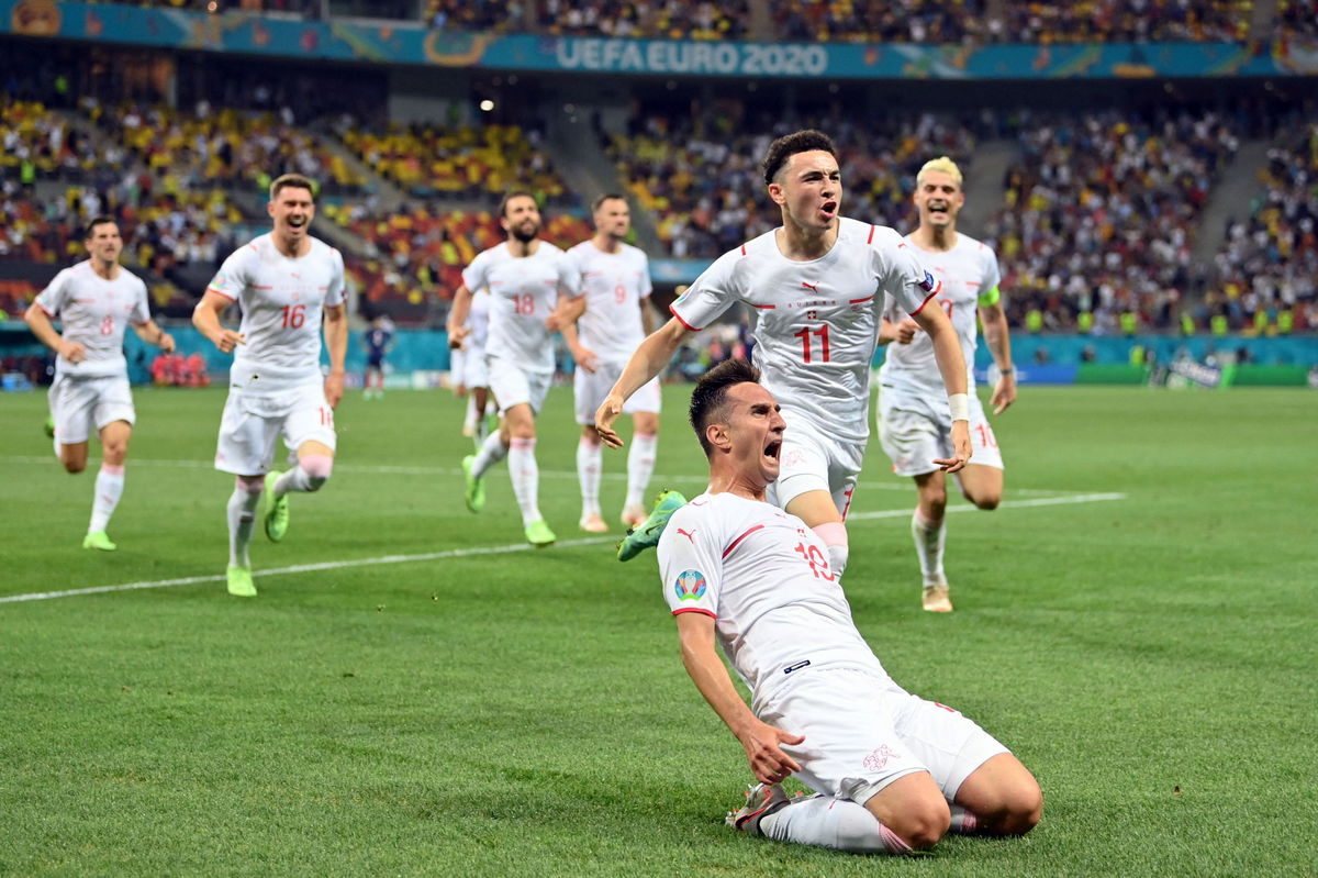 <i>JUSTIN SETTERFIELD/AFP/POOL/AFP via Getty Images</i><br/>Switzerland's forward Mario Gavranovic celebrates scoring his team's late equalizing goal.