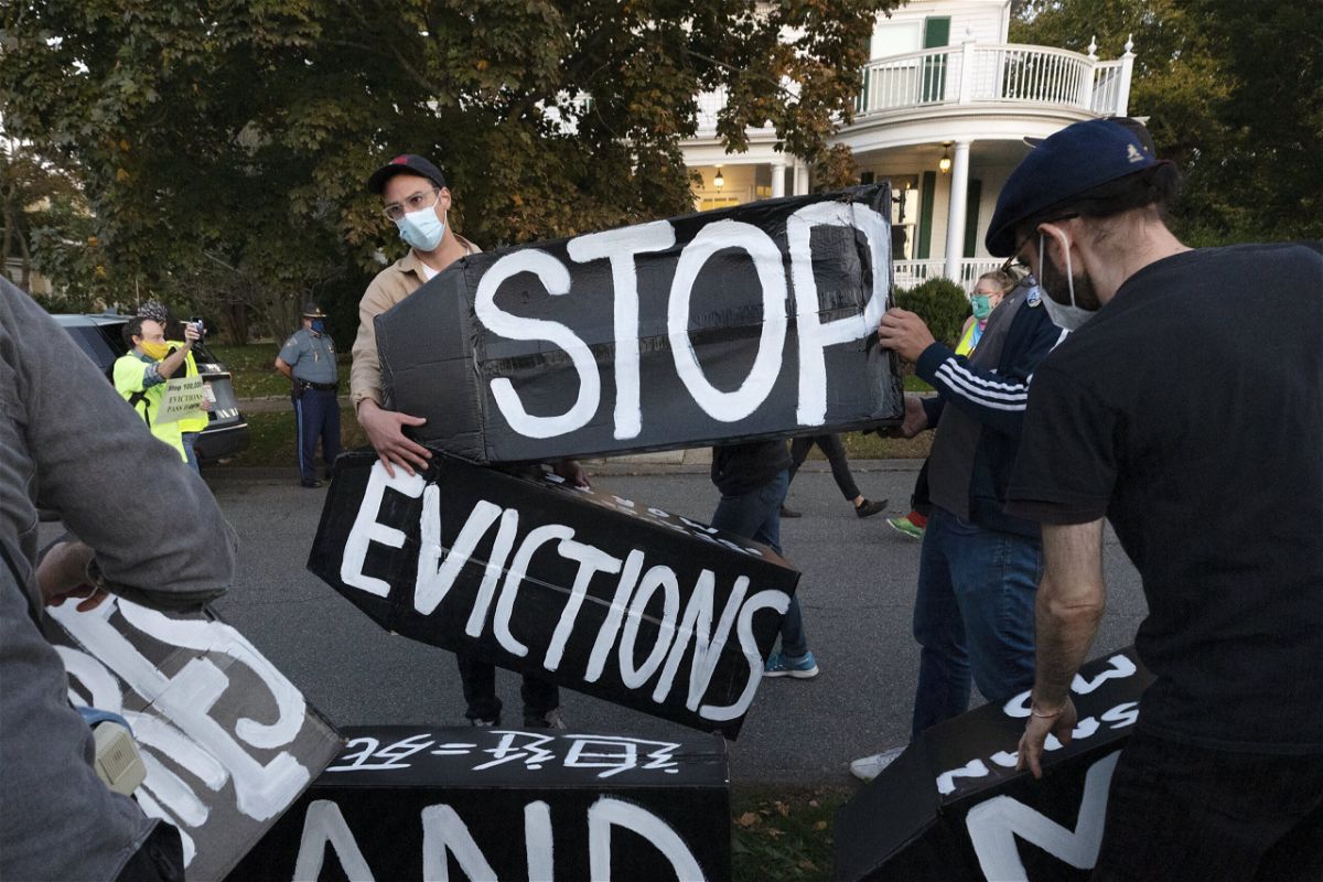 <i>Michael Dwyer/AP</i><br/>The White House announced Thursday that it would not ask the CDC to again extend the protection to ban evictions. Housing activists are shown erecting a sign in Swampscott