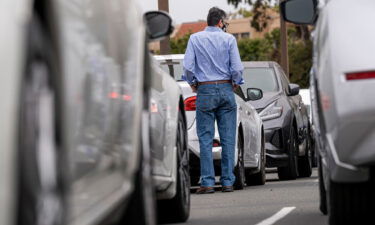 A customer shops for vehicles at a car dealership in Richmond