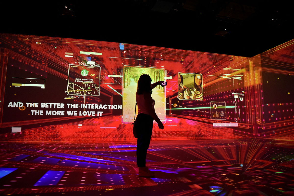 <i>Pau Barrena/AFP/Getty Images</i><br/>Mobile World Congress is one of the first big tech conferences to bring back in-person attendees and pictured is a woman at the Mobile World Congress fair in Barcelona on June 28.