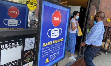 People shop at a grocery store enforcing the wearing of masks in Los Angeles on July 23