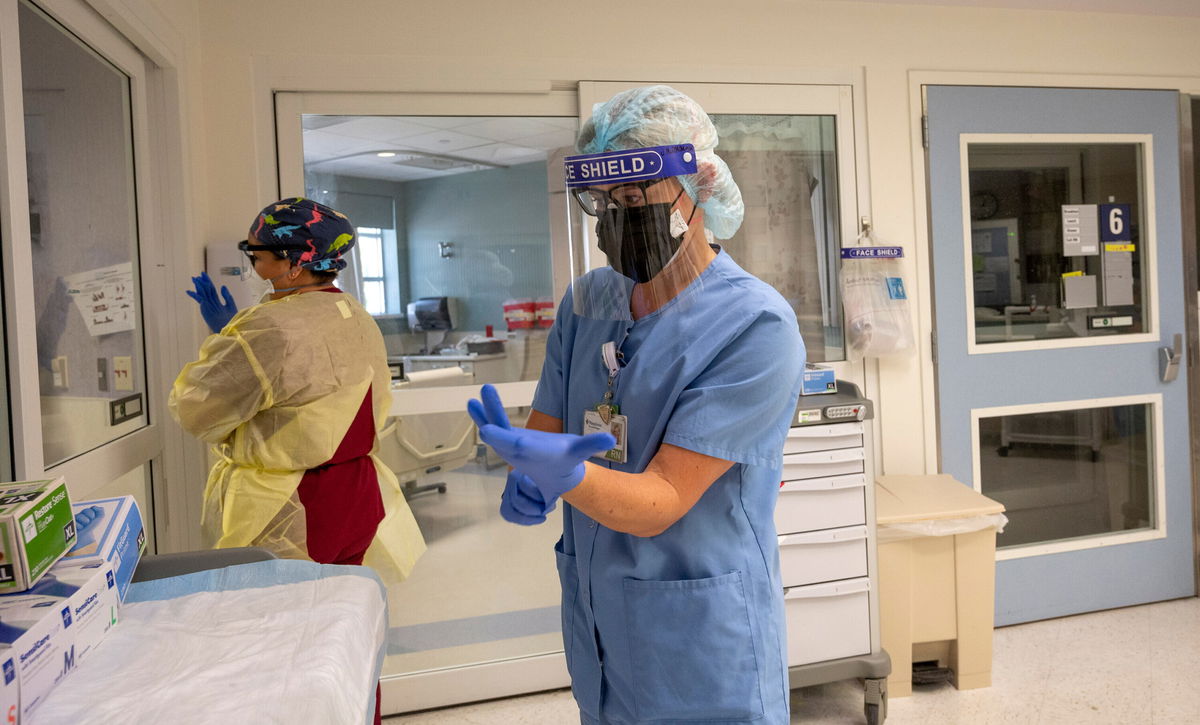 <i>Paul Bersebach/MediaNews Group/Orange County Register/Getty Images</i><br/>A CNN analysis shows average Covid-19 hospitalization rates are nearly three times higher among states that have fully vaccinated as Nurses Assistant Vanessa Gutierrez