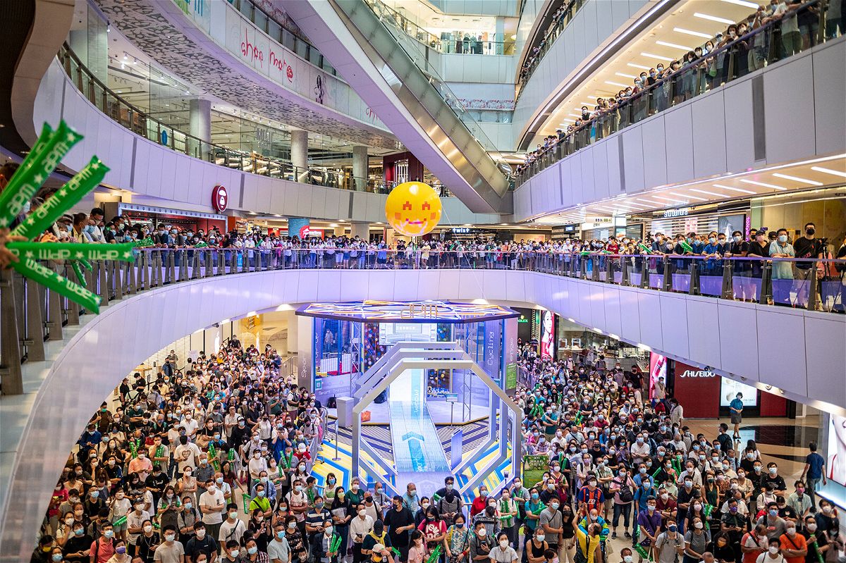 <i>Vernon Yuen/NurPhoto/AP</i><br/>People are shown at a shopping mall in Hong Kong watching Siobhan Haughey swim in the 100-meter freestyle Olympics final on Friday. Hong Kong police have arrested a man after he allegedly booed the Chinese national anthem while watching an Olympics award ceremony inside a shopping mall..