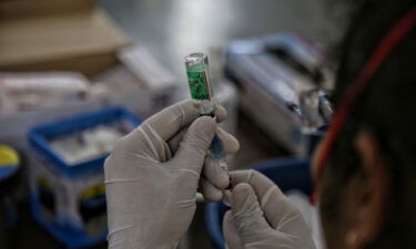 A health worker prepares a dose from a vial of Covishield vaccine at a Covid-19 vaccination centre