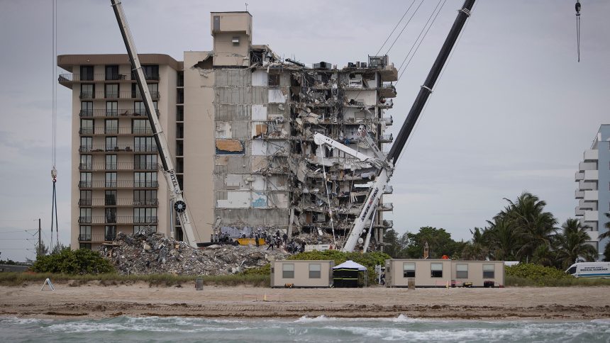 Search and rescue teams look for possible survivors in the partially collapsed 12-story Champlain Towers South condo building in Surfside