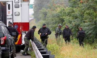 Police working in the area of the hourslong standoff with a group of armed men.