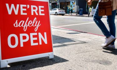 A sign announces that a restaurant is "safely open" in Los Angeles