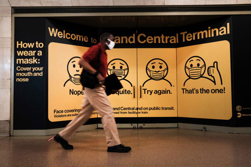 A person wears a mask while walking in Grand Central Terminal on July 27 in New York City.