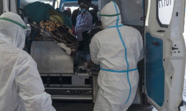 Health workers arrive with a patient at the Chris Hani Baragwanath Academic Hospital's COVID-19 facility