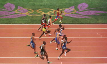 Linford Christie of Great Britain wins his heat in the first round of the men's 100m at the 1996 Centennial Games in in Atlantia