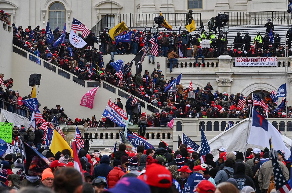WASHINGTON, DC - JANUARY 6: Protesters take over the Inaugural stage during a protest calling for legislators to overturn the election results in President Donald Trump's favor at the U.S. Capitol on January 6, 2021 in Washington, D.C. 
